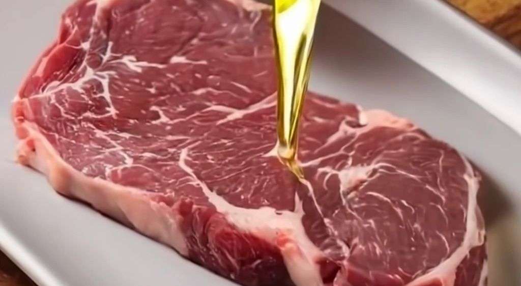 Pouring Oil on Steak Before Grilling